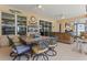 A covered patio features a dining area, ceiling fans, and an outdoor kitchen to enjoy at 16200 E Shirley Shores Rd, Tavares, FL 32778