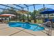 Inviting screened-in pool area, complete with patio furniture and lush landscaping at 16200 E Shirley Shores Rd, Tavares, FL 32778
