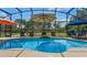 Backyard pool featuring waterfall, sun shelf and view to gazebo and backyard at 16200 E Shirley Shores Rd, Tavares, FL 32778