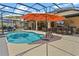 Inviting pool area with a screened enclosure, covered patio, and outdoor kitchen at 16200 E Shirley Shores Rd, Tavares, FL 32778