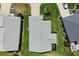 Aerial shot of roof and backyard reveals a beautifully maintained property with lush lawn and landscape at 1633 Manserra St, The Villages, FL 32163