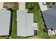 A unique aerial perspective showcasing the home's roof, backyard, and screened-in patio features at 1633 Manserra St, The Villages, FL 32163