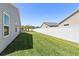 Spacious backyard with well-maintained lawn and privacy fence, perfect for outdoor activities at 1633 Manserra St, The Villages, FL 32163
