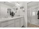 Well-lit bathroom with double sinks, a walk-in shower, and an abundance of storage at 1633 Manserra St, The Villages, FL 32163