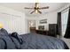 Spacious bedroom features a ceiling fan and large windows, offering a serene retreat at 1633 Manserra St, The Villages, FL 32163