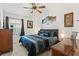 Comfortable bedroom featuring a ceiling fan, natural light, and warm, neutral walls at 1633 Manserra St, The Villages, FL 32163