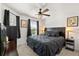 Cozy bedroom with a ceiling fan, neutral paint, and windows for plenty of natural light at 1633 Manserra St, The Villages, FL 32163