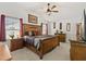 Charming bedroom with a large bed, plenty of light, and wooden accents at 1633 Manserra St, The Villages, FL 32163
