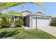 Attractive single-story home boasting a two-car garage, lush lawn, and appealing curb appeal at 1633 Manserra St, The Villages, FL 32163