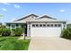 Lovely single-story home with a spacious two-car garage, green lawn, and well-maintained landscaping at 1633 Manserra St, The Villages, FL 32163