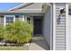 A welcoming front entrance featuring a covered porch and well-maintained landscaping at 1633 Manserra St, The Villages, FL 32163