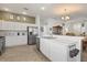 Bright kitchen features stainless steel appliances, light wood flooring, and quartz countertops at 1633 Manserra St, The Villages, FL 32163