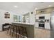 Kitchen featuring breakfast bar, stainless steel appliances, and neutral countertops at 1633 Manserra St, The Villages, FL 32163