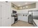 Well-lit kitchen featuring stainless steel appliances and white cabinets at 1633 Manserra St, The Villages, FL 32163