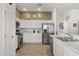 Updated kitchen featuring white cabinets, stainless steel appliances, and neutral paint at 1633 Manserra St, The Villages, FL 32163