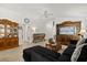 Bright living room showcasing wood cabinets, neutral flooring, and a dark comfortable sectional at 1633 Manserra St, The Villages, FL 32163