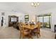 Open-concept living space with dining table, living area, and access to the screened lanai at 1633 Manserra St, The Villages, FL 32163