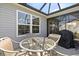 Relaxing covered patio with comfortable seating, perfect for outdoor dining and entertaining with an attached grill at 1633 Manserra St, The Villages, FL 32163