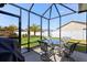 Enjoy the outdoor space on this screened patio with a lush green yard view and comfortable seating at 1633 Manserra St, The Villages, FL 32163