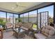 Inviting sunroom with wicker furniture, decorative screens and plenty of sunlight at 1633 Manserra St, The Villages, FL 32163