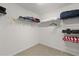 Spacious walk-in closet with carpeted floors and extensive shelving for optimal storage and organization at 1633 Manserra St, The Villages, FL 32163