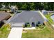 An aerial view of a well-maintained house with a new roof and fenced backyard at 16380 Se 84Th Ct, Summerfield, FL 34491