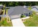 Aerial view of home with manicured lawn, mature trees and well-maintained landscaping at 16380 Se 84Th Ct, Summerfield, FL 34491