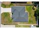 An overhead view captures the full layout of this home's roof and property, revealing its well-maintained lawn and surroundings at 16380 Se 84Th Ct, Summerfield, FL 34491