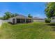 Expansive backyard with lush green lawn and screened patio perfect for outdoor living at 16380 Se 84Th Ct, Summerfield, FL 34491