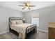 Cozy bedroom with a ceiling fan, natural light, and comfortable furnishings at 16380 Se 84Th Ct, Summerfield, FL 34491