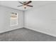 Bright, spacious bedroom with a ceiling fan, large window, and plush carpeting at 16380 Se 84Th Ct, Summerfield, FL 34491