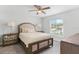 Light-filled bedroom with a large window, ceiling fan, and stylish furnishings at 16380 Se 84Th Ct, Summerfield, FL 34491