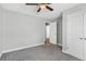 Cozy bedroom features a ceiling fan, plush carpet, and ample space at 16380 Se 84Th Ct, Summerfield, FL 34491