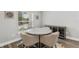 Cozy dining area with modern table and chairs near a bright window at 16380 Se 84Th Ct, Summerfield, FL 34491