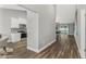 Hallway featuring wood flooring, a view of the kitchen, and the living room at 16380 Se 84Th Ct, Summerfield, FL 34491