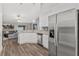 Open-concept kitchen with stainless steel refrigerator and access to living area at 16380 Se 84Th Ct, Summerfield, FL 34491