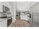 Modern kitchen with stainless steel appliances and an open view to the living room at 16380 Se 84Th Ct, Summerfield, FL 34491