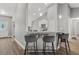 Stylish kitchen counter with pendant lights and seating for three at 16380 Se 84Th Ct, Summerfield, FL 34491