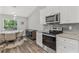 Kitchen featuring granite countertops and stainless steel oven and microwave at 16380 Se 84Th Ct, Summerfield, FL 34491