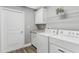 Functional laundry room equipped with modern appliances and ample storage space at 16380 Se 84Th Ct, Summerfield, FL 34491