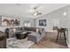 Open concept living room with vaulted ceilings, a view of backyard, and large gray sofa at 16380 Se 84Th Ct, Summerfield, FL 34491