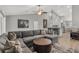 Open-concept living room featuring vaulted ceilings, and gray sectional sofa at 16380 Se 84Th Ct, Summerfield, FL 34491