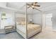 Spacious bedroom with a stylish canopy bed and tray ceiling at 16380 Se 84Th Ct, Summerfield, FL 34491