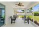 Covered patio with tiled flooring and outdoor seating, perfect for relaxing at 16380 Se 84Th Ct, Summerfield, FL 34491