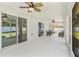 Spacious covered patio with ceiling fans, seating and access to the outdoors at 16380 Se 84Th Ct, Summerfield, FL 34491