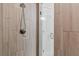 Close-up of a tiled walk-in shower featuring modern fixtures and a glass door at 16380 Se 84Th Ct, Summerfield, FL 34491