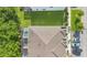 An aerial view of the home featuring a screened-in pool area, grassy yard, and parking spaces at 17519 Hidden Forest Dr, Clermont, FL 34714