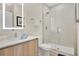 Modern bathroom featuring a glass-enclosed shower and a stylish vanity with a backlit mirror at 17519 Hidden Forest Dr, Clermont, FL 34714