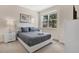 Inviting bedroom with a neutral palette, featuring a queen bed, side table, and bright window views at 17519 Hidden Forest Dr, Clermont, FL 34714