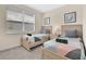 Cozy bedroom with two twin beds, a nightstand, and a window with blinds for privacy at 17519 Hidden Forest Dr, Clermont, FL 34714